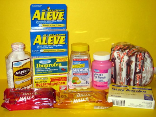 bottles of pain relievers, antacids, rolls of throat drops, caffeine pills, candy