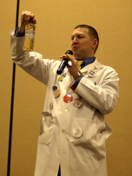Kage looking at a plastic bottle of wine.