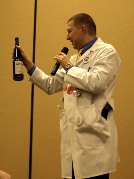 Kage holding a glass wine bottle