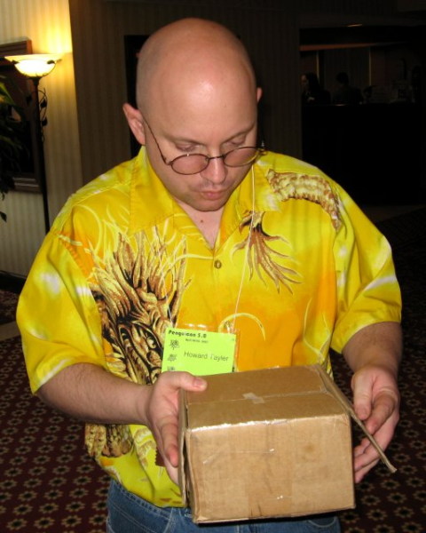 Howard Tayler opening a parcel
