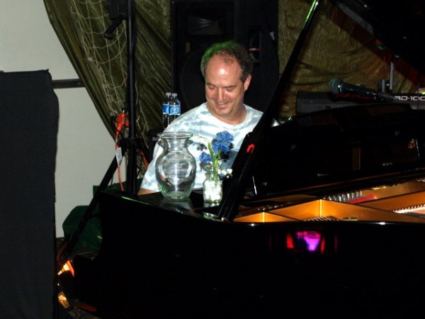 tip jar and flower arrrangement on the piano
