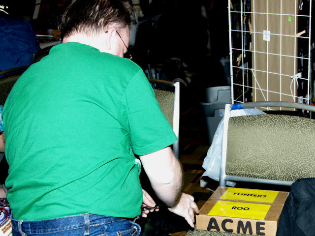 Flinters about to open a parcel that is sitting on a chair