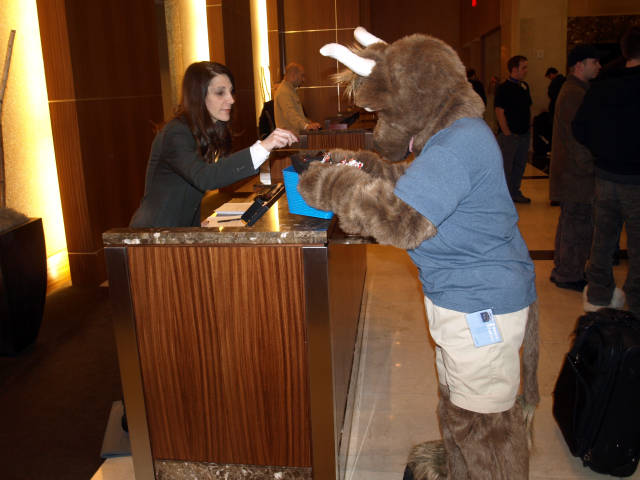 Hotel clerk selecting a piece of candy.