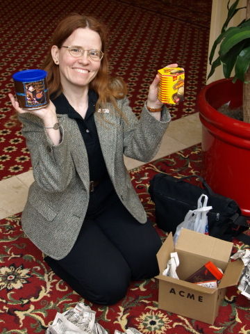 Cathy holding up chocolate drink mixes.