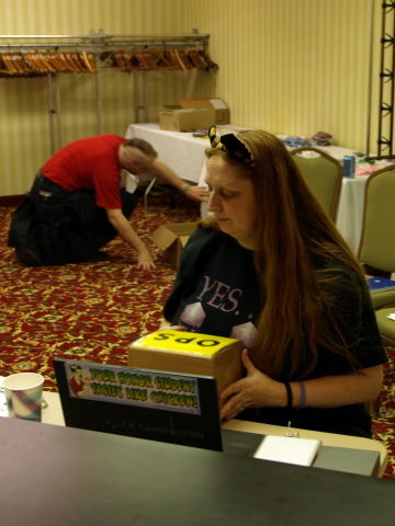 Penguicon operation volunteer holding a parcel.