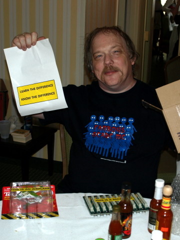 Eric holding up a card that reads 'Learn the difference.  Know the difference.'